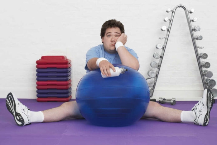 Portrait,Of,A,Tired,Overweight,Man,Sitting,On,Floor,With
