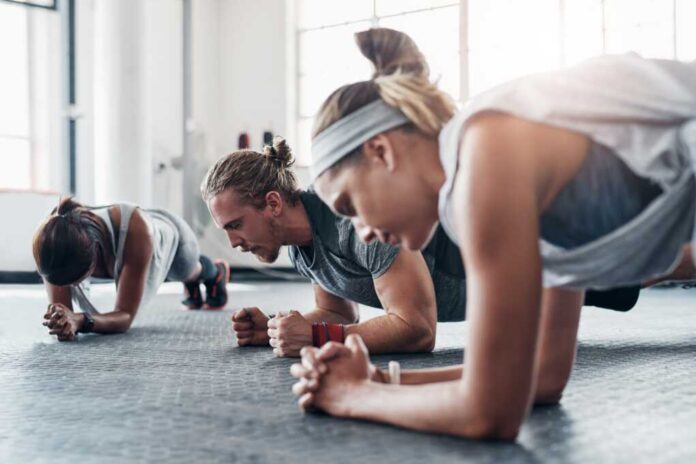 Fitness,,Personal,Trainer,And,Plank,Exercise,With,Group,,Healthy,Workout