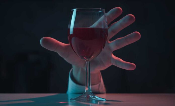 The,Alcoholic's,Hand,Reaches,For,A,Glass,Of,Wine.,Alcohol