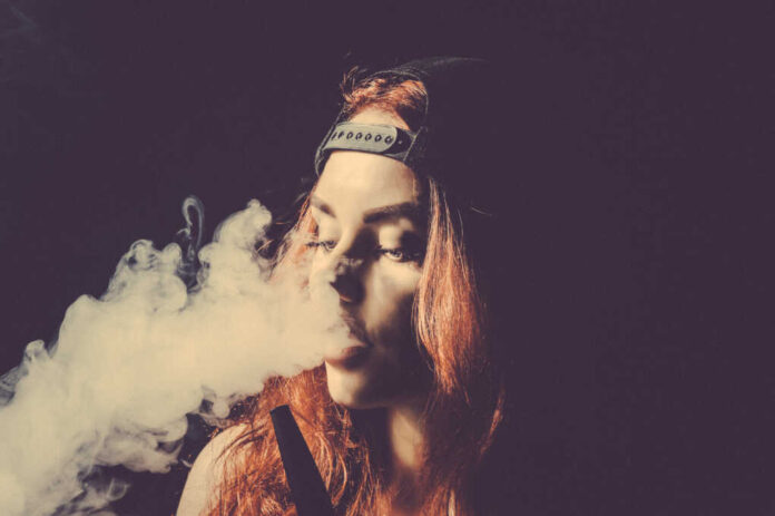 Red-haired,Sexy,Girl,Dressed,In,Swimsuit,And,Cap,Smoking,A