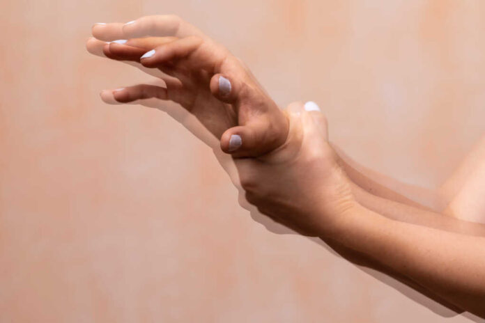 A,Closeup,View,On,The,Violently,Shaking,Hands,Of,A