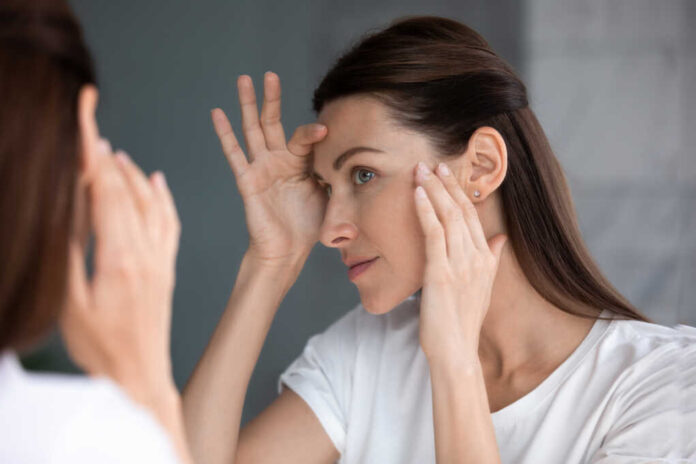 Close,Up,Of,Woman,Looking,In,Mirror,Check,Face,After