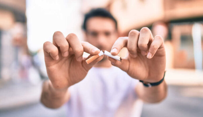 Young,Hispanic,Man,Breaking,Cigarette,With,Hands,Walking,At,The