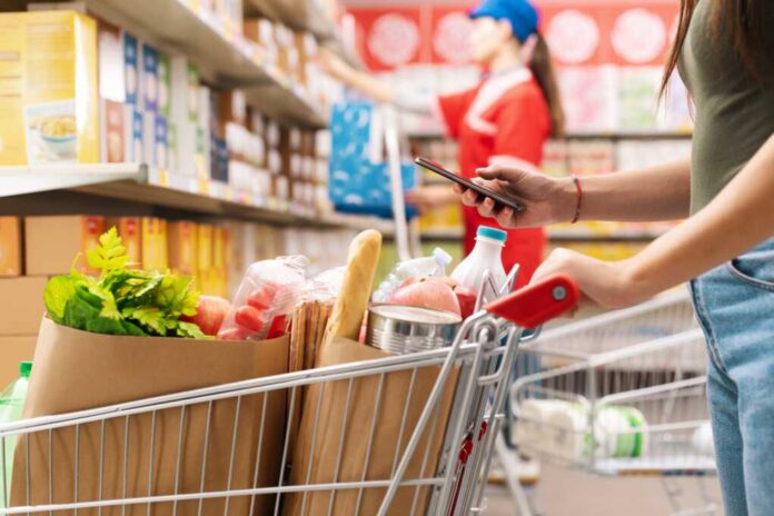 Woman,Buying,Groceries,At,The,Supermarket,,She,Is,Pushing,A