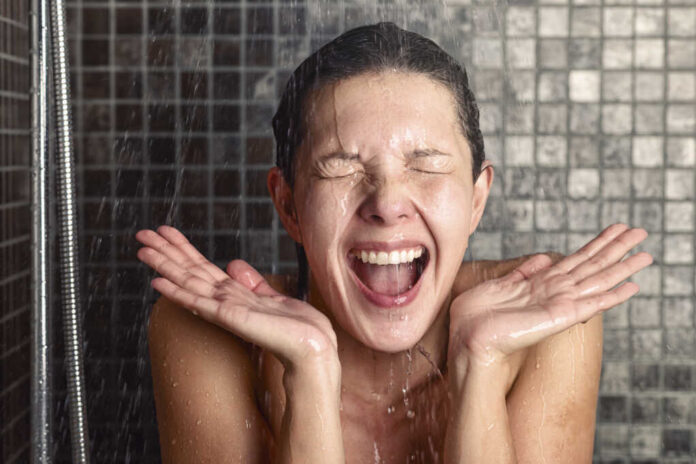 Young,Woman,Reacting,In,Shock,To,Hot,Or,Cold,Shower