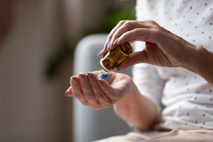 Close,Up,Mature,Woman,Taking,Out,Pills,From,Bottle,,Supplements