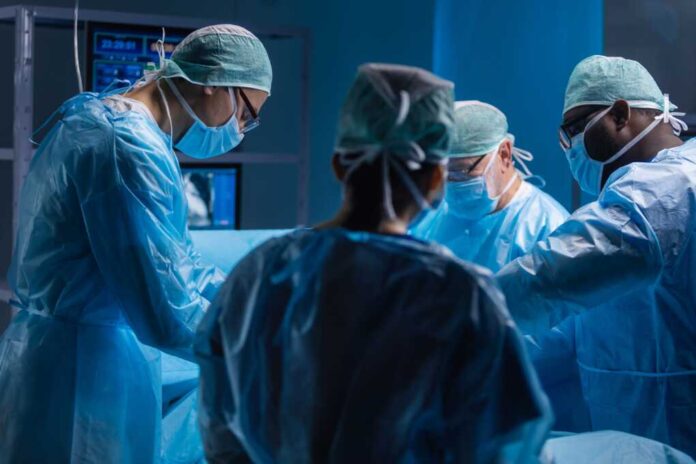 Multiracial,Team,Of,Professional,Medical,Surgeons,Performs,The,Surgical,Operation