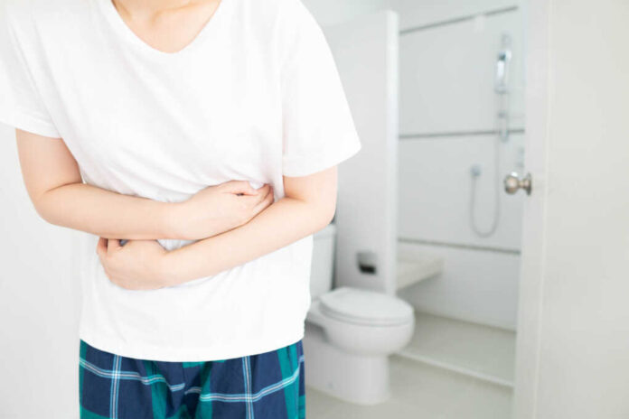 Young,Female,Suffering,Form,Abdominal,Pain,In,Front,Of,Toilet