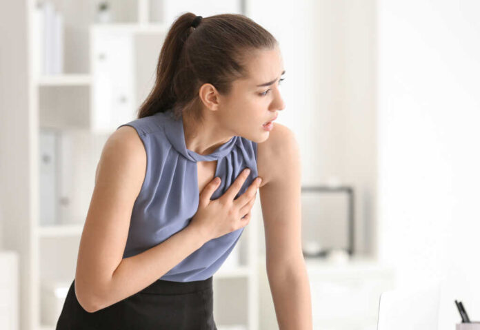 Young,Woman,Suffering,From,Heart,Attack,In,Office
