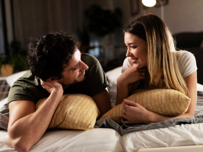 Young,Loving,Couple,Relaxing,On,Bed,Together.,Happy,Couple,Watching