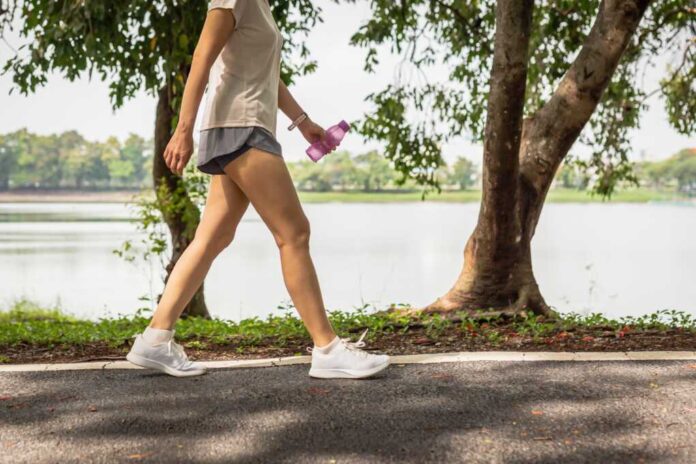 Woman,Walking,In,The,Park,With,Bottle,Water,In,Her