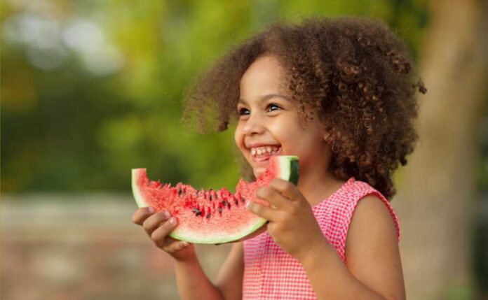 Funny,Black,Kid,Eating,Watermelon,Outdoors,In,Hot,Summer.,Laughing