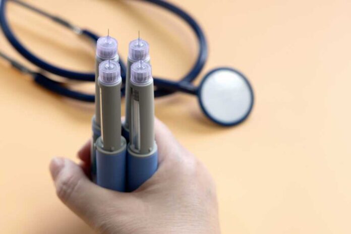 Women's,Hands,Holding,Blue,Insulin,Injection,Pen,For,Diabetics,And