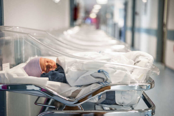 Newborn,Baby,In,First,Of,Many,Small,Hospital,Beds