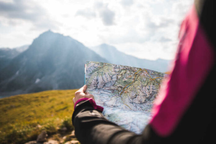 Adventurous,Girl,Navigating,In,With,A,Topographic,Map,In,The