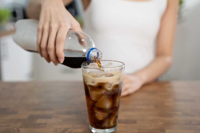 Woman,Pouring,Soda,To,Glass,For,A,Refreshing,Drink