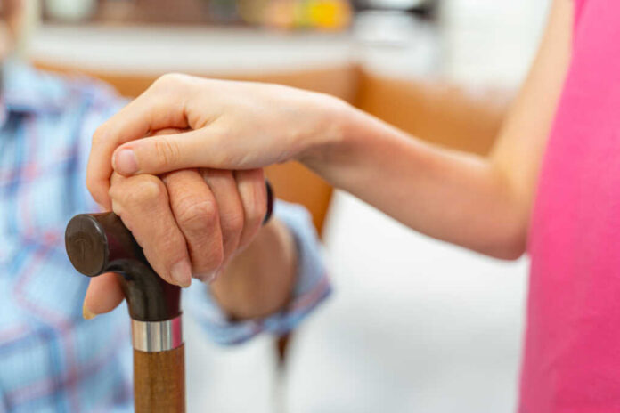 Cropped,Photo,Of,Two,Pairs,Of,Hands,Resting,On,A