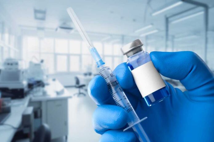 Doctor,In,Blue,Protective,Gloves,Hold,Vaccine