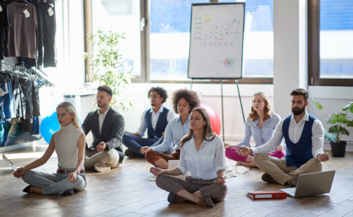 Group,Of,Business,Colleagues,Meditating,At,Work,,Sitting,On,The