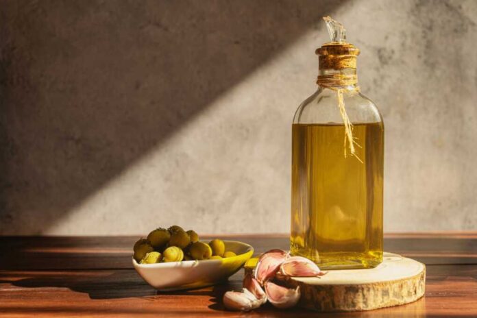 Olive,Oil,Bottle,With,Olives,And,Garlic