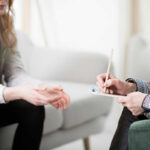 TV Addiction Secretly Stealing Mental Health Two individuals engaged in a counseling session, one taking notes