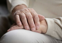 Two hands gently resting on each other, symbolizing care and connection