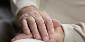 Two hands gently resting on each other, symbolizing care and connection