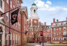View of a university campus featuring brick buildings and a prominent clock tower
