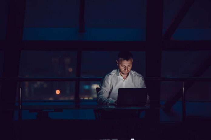Businessman,Working,On,Laptop,In,Night,Office.