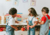 Play Therapy Outshines Complex Trauma Treatments Three children engaged in play with educational toys in a colorful classroom
