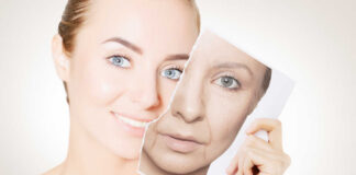 A woman holding a photo showing her younger and older self