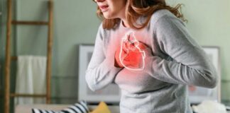 Woman holding her chest in discomfort with a heart illustration