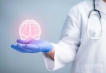 Brain On Fire Breakthrough Stuns Researchers A medical professional holding a glowing digital brain illustration in their hand