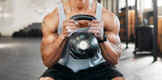 Athlete performing a kettlebell squat in a gym