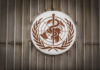World Health Organization emblem featuring a globe and caduceus