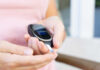 Person using a blood glucose meter to check their blood sugar level