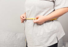 BMI’s Shocking Misclassification Rate Exposed Person measuring their waist with a tape measure
