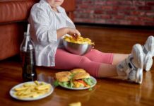 Refined Carbs: Comfort Food or Anxiety Fuel? Child sitting on the floor enjoying snacks from a bowl