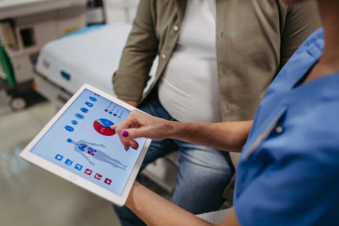 Nurse showing a patient health data on a tablet