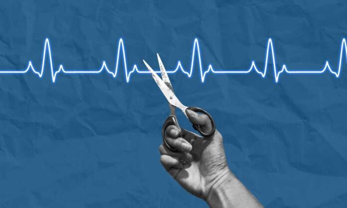 A hand holding scissors above a heartbeat line on a blue background