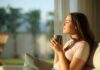 Woman enjoying a cup of coffee in a sunlit room
