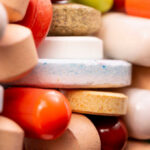 Alzheimer’s Meds: Hidden Brain Risks Exposed A close-up view of a variety of colorful pills and tablets stacked together