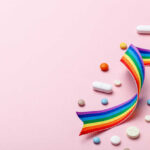 Antidepressants and Heart Death Risk Colorful pills and a rainbow ribbon on a pink background