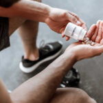 Creatine: Fountain of Youth or Overhyped? Person pouring probiotic pills into their hand