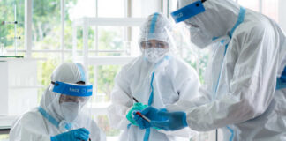 Scientists in protective suits conducting research in a laboratory