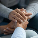 Surprising Handshake Study: Mental Health Red Flag Two hands clasped together in a comforting gesture