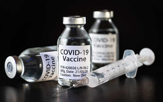 Coronavirus,Covid-19,Vaccine,Concept,-,Three,Glass,Vials,On,Black Vials of COVID-19 vaccine and a syringe on a dark background