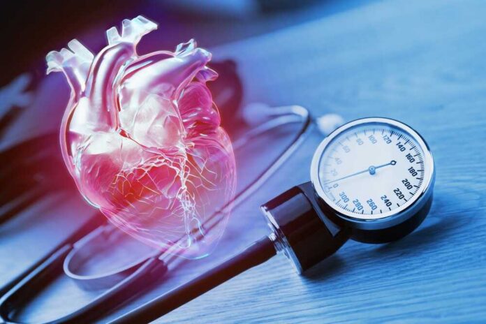 An anatomical heart illustration next to a blood pressure monitor