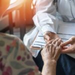 Muscle Loss Battle: Vitamin D vs. Trendy Supplements A doctor holding the hand of an elderly patient during a consultation