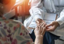Muscle Loss Battle: Vitamin D vs. Trendy Supplements A doctor holding the hand of an elderly patient during a consultation